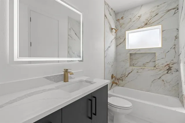 a view of a room with wooden floor and windows