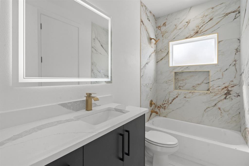 1849 Pollard Street Dallas, TX 75208 - Photo 7 of 10 a bathroom with a sink a toilet and shower