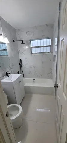 a bathroom with a sink a toilet and a bathtub