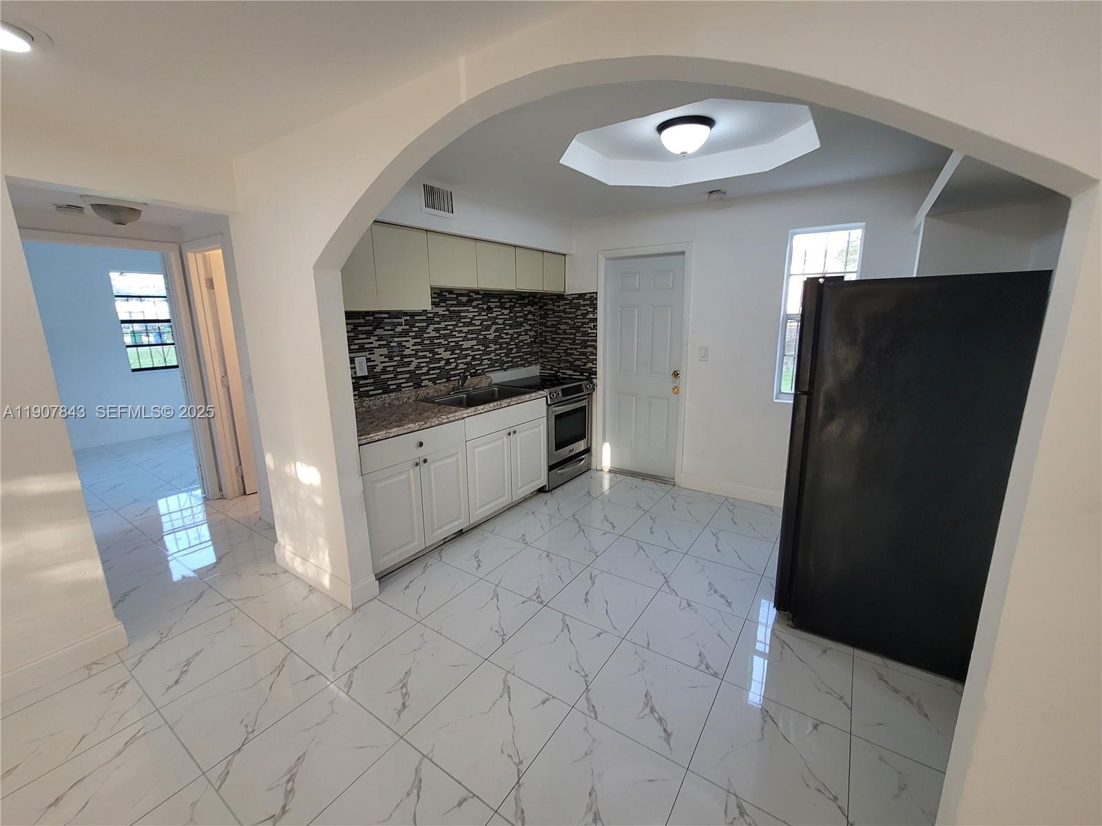 11275 Northwest 17th Avenue Miami, FL 33167 - Photo 19 of 21 a view of a refrigerator in kitchen and entryway