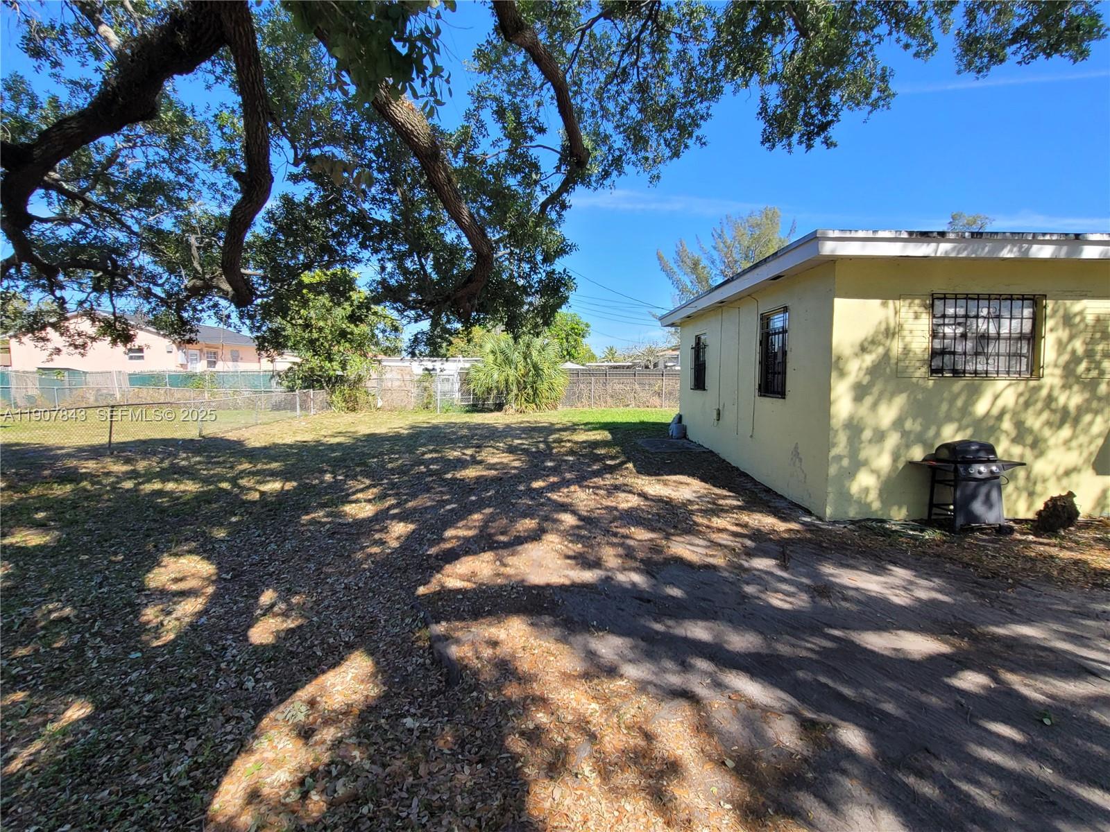 11275 Northwest 17th Avenue Miami, FL 33167 - Photo 5 of 21 a view of a house with a yard