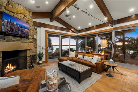 a bedroom with a large bed and a chandelier