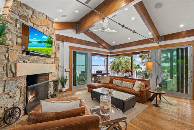 a bathroom with a granite countertop sink a mirror and next to a window