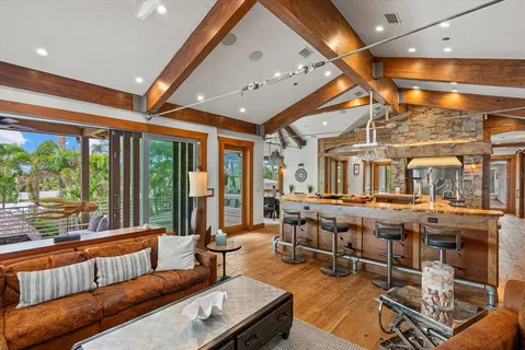 a living room with furniture a large window with wooden floor