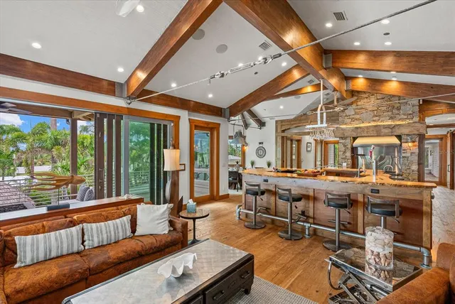 a living room with furniture a large window with wooden floor