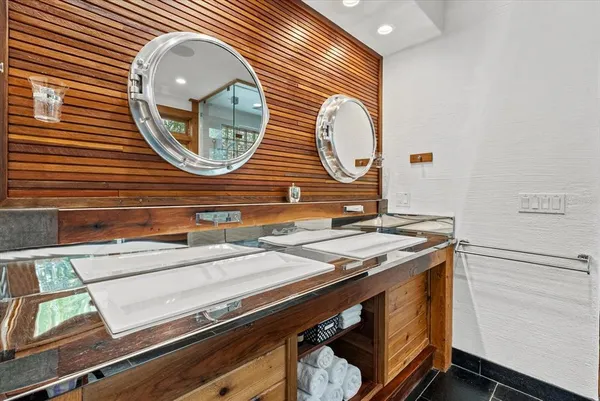 a balcony with wooden floor table and chairs