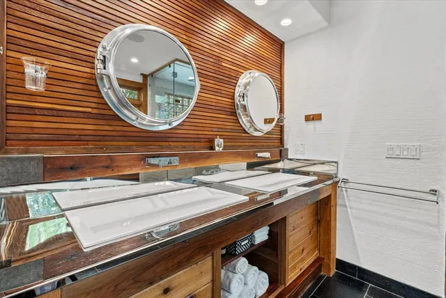 a balcony with wooden floor table and chairs