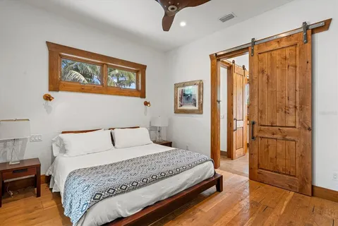 a bedroom with a large bed and a window