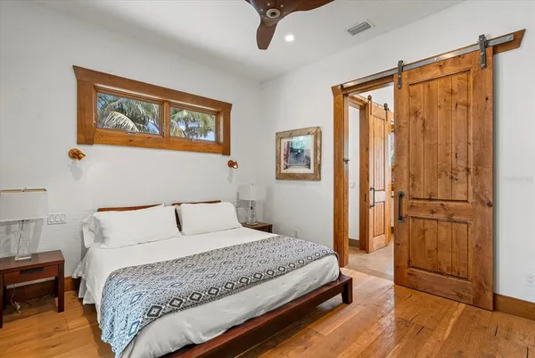 a bedroom with a large bed and a window