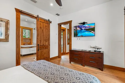 a bedroom with a bed and a flat screen tv