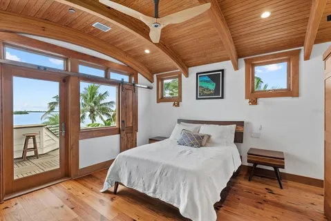 a living room with patio furniture and a floor to ceiling window