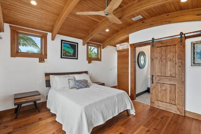 a living room with furniture and a painting on the wall