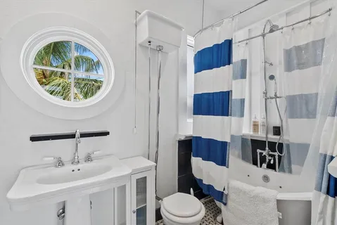 a bathroom with a window and a shower