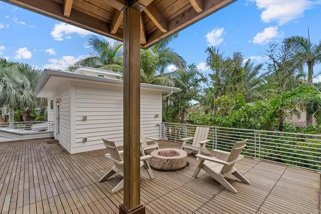 a view of a swimming pool with lawn chairs under an umbrella