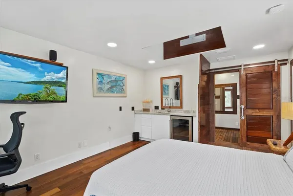 a patio with wooden floor and outdoor seating