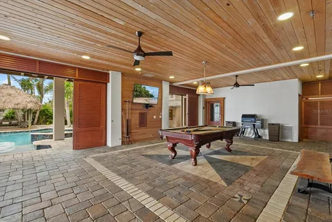 a view of a patio with table and chairs potted plants and palm trees