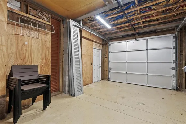 a view of a backyard with table and chairs and potted plants