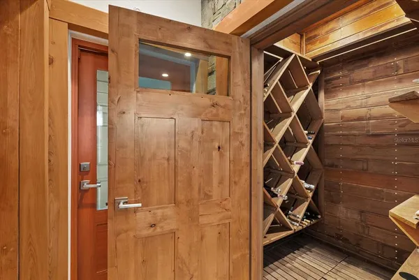 a living room with furniture a fireplace and a floor to ceiling window