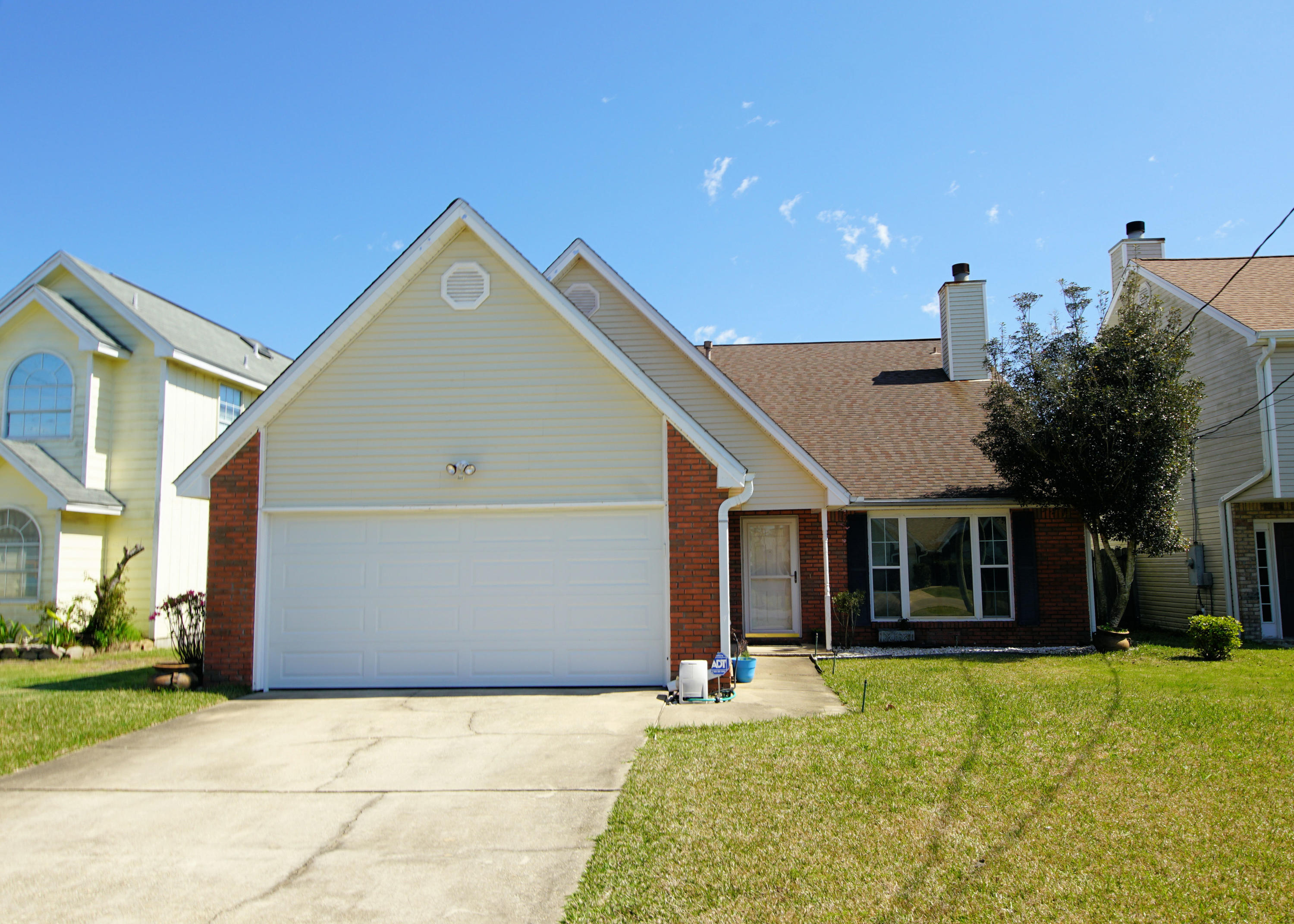 467 Sandy Ridge Circle Mary Esther, FL 32569 - Photo 1 of 37 a front view of a house with a yard and garage