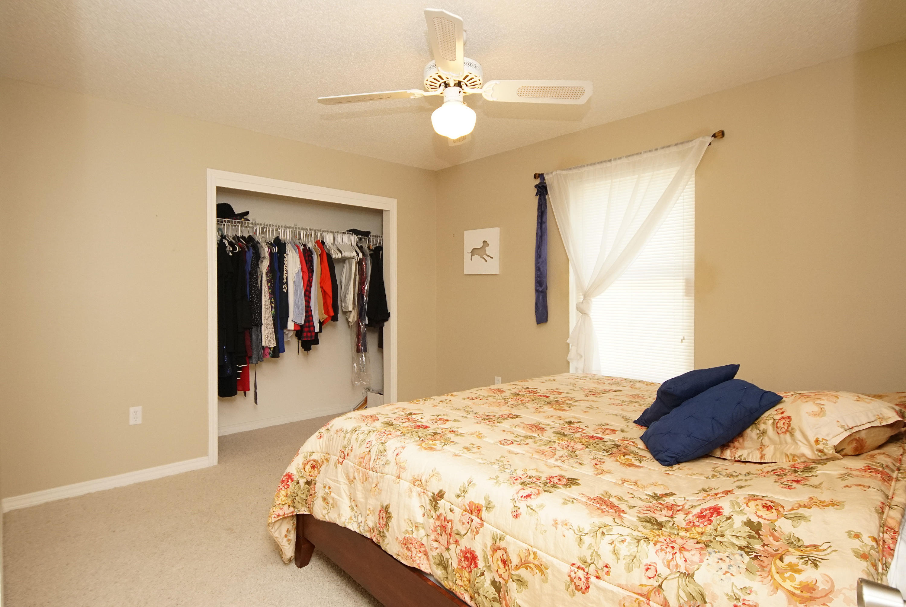 467 Sandy Ridge Circle Mary Esther, FL 32569 - Photo 30 of 37 a bedroom with a bed and a chandelier