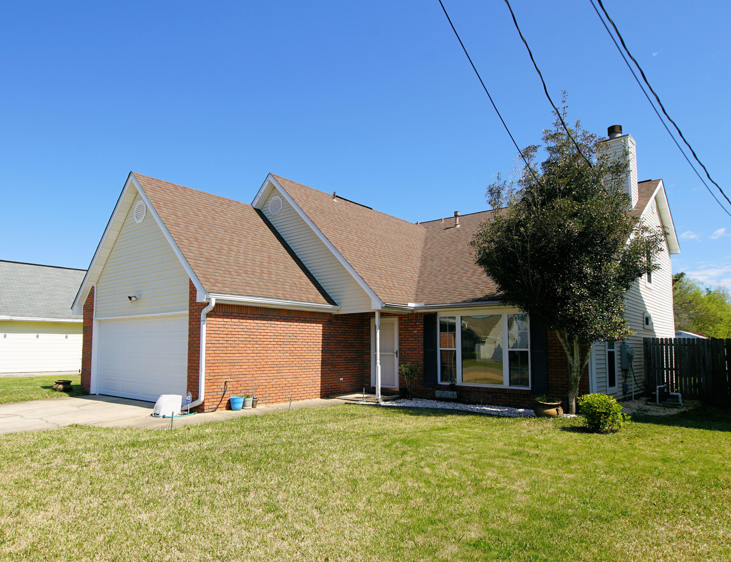 467 Sandy Ridge Circle Mary Esther, FL 32569 - Photo 3 of 37 a view of a house with a backyard and a tree