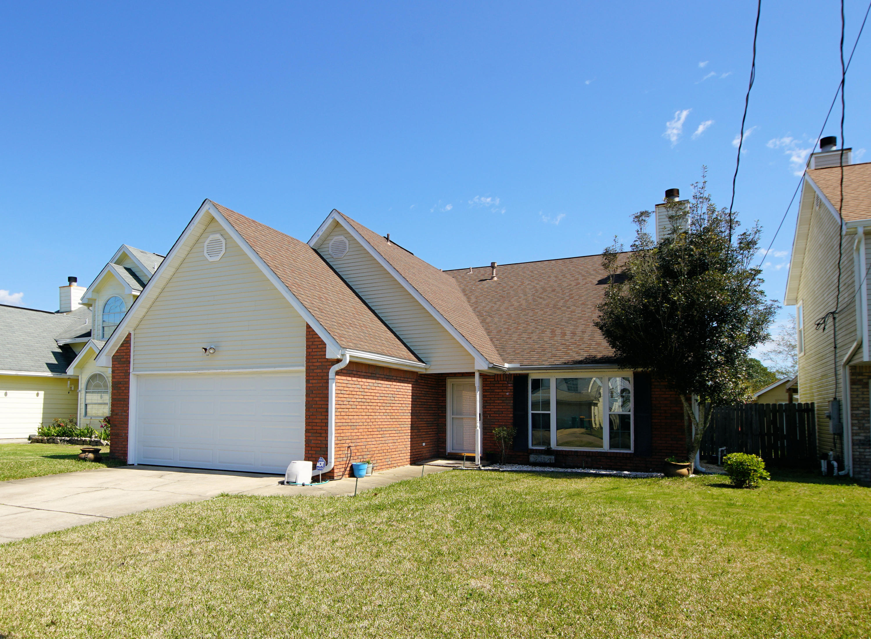467 Sandy Ridge Circle Mary Esther, FL 32569 - Photo 4 of 37 a view of a house with a yard and garage