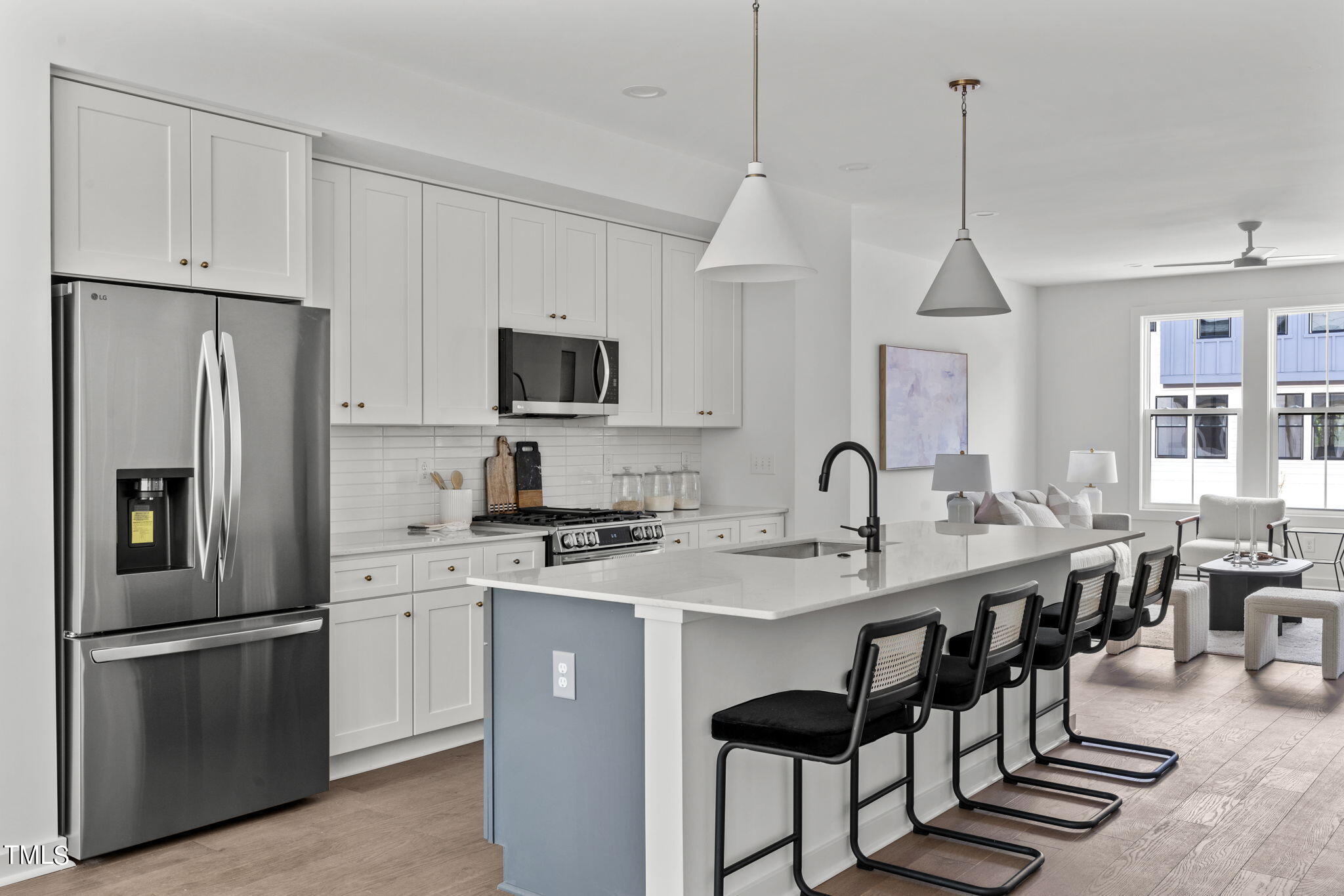 6420 Tanner Oak Lane Raleigh, NC 27613 - Photo 2 of 49 a kitchen with stainless steel appliances granite countertop a stove a sink a refrigerator a center island and cabinets