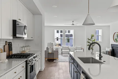 a kitchen with stainless steel appliances a sink stove and cabinets