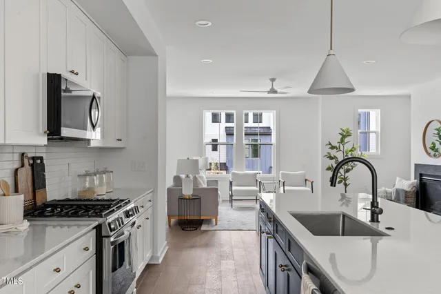 a kitchen with stainless steel appliances a sink stove and cabinets