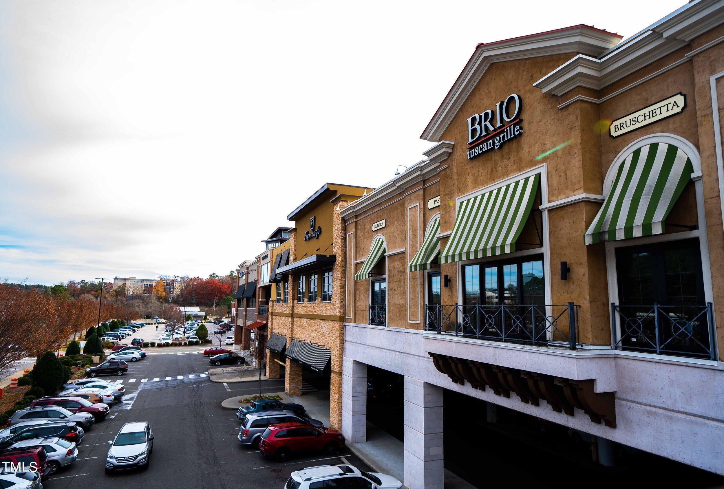6420 Tanner Oak Lane Raleigh, NC 27613 - Photo 46 of 50 a city street lined with buildings and cars
