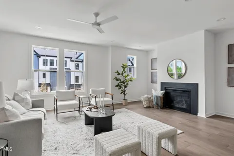 a living room with furniture a fireplace and a window