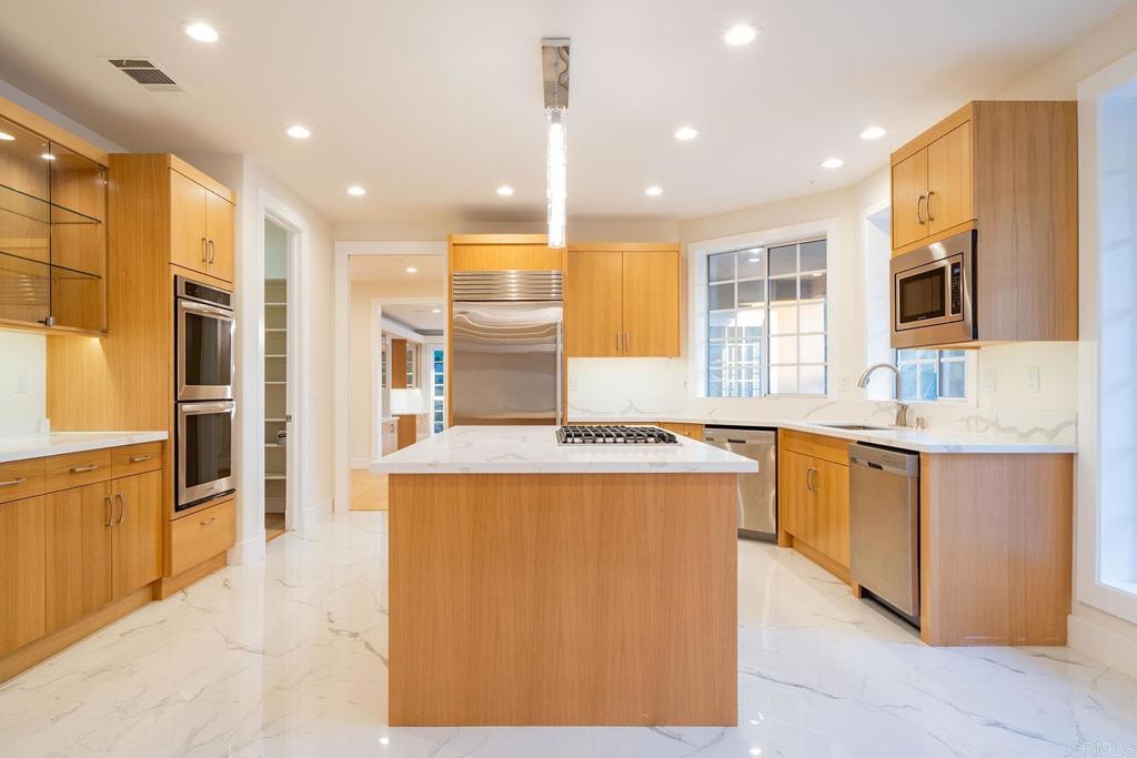 41965 Mesa Verdugo Temecula, CA 92592 - Photo 33 of 68 a kitchen with stainless steel appliances granite countertop a refrigerator a sink dishwasher and a stove with wooden floor