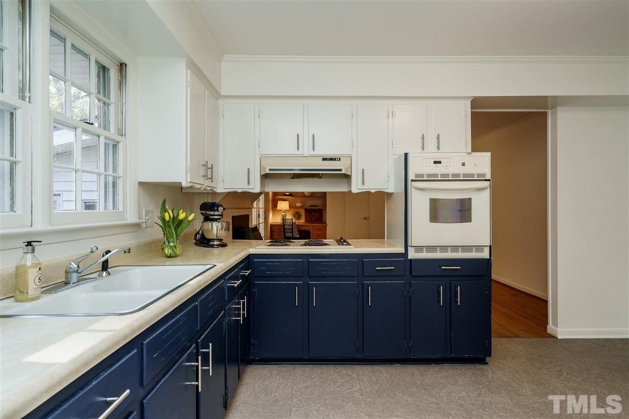 4224 Rowan Street Raleigh, NC 27609 - Photo 11 of 24 a kitchen with cabinets and window