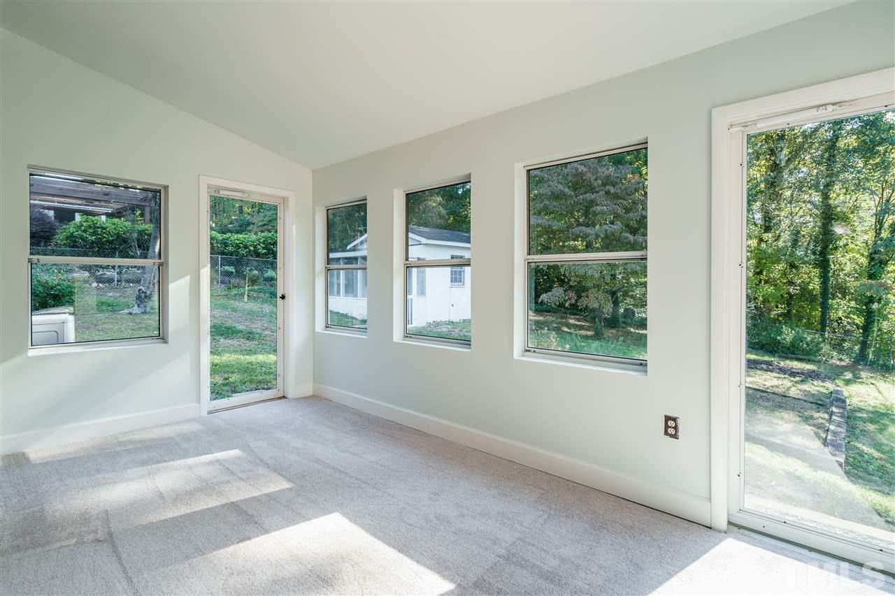 4224 Rowan Street Raleigh, NC 27609 - Photo 14 of 24 a view of an empty room with large windows