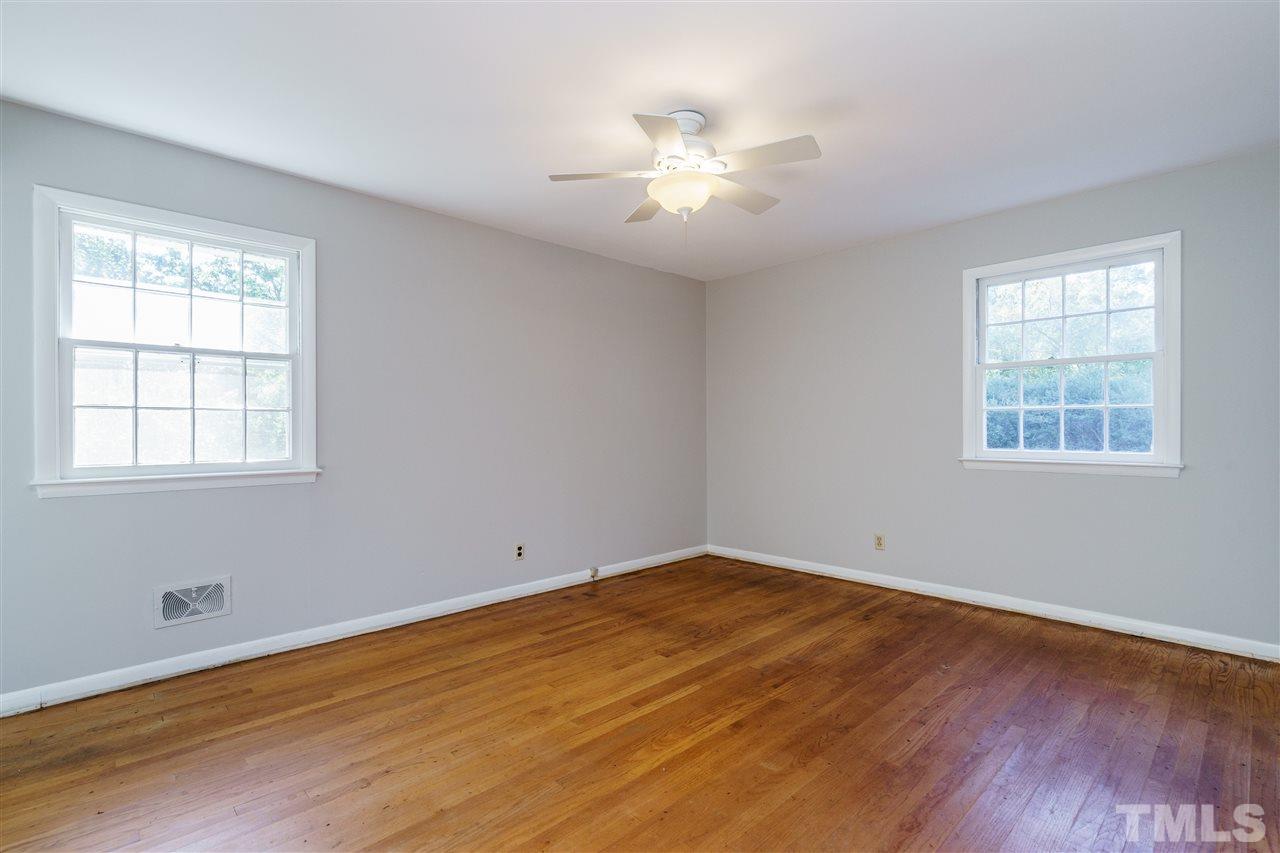 4224 Rowan Street Raleigh, NC 27609 - Photo 16 of 24 a view of a room with wooden floor and windows