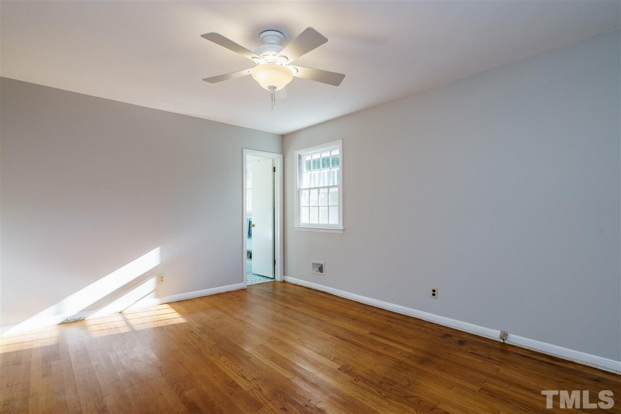 4224 Rowan Street Raleigh, NC 27609 - Photo 17 of 24 an empty room with wooden floor and windows