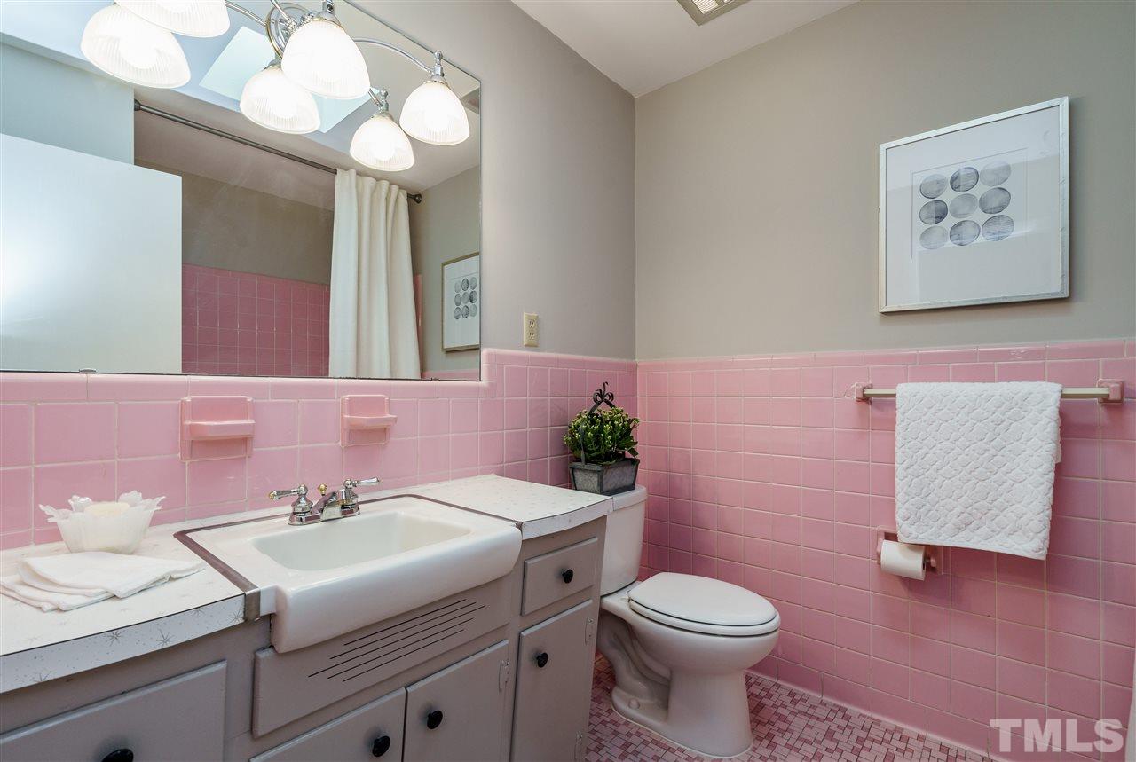 4224 Rowan Street Raleigh, NC 27609 - Photo 20 of 24 a bathroom with a sink a toilet and mirror