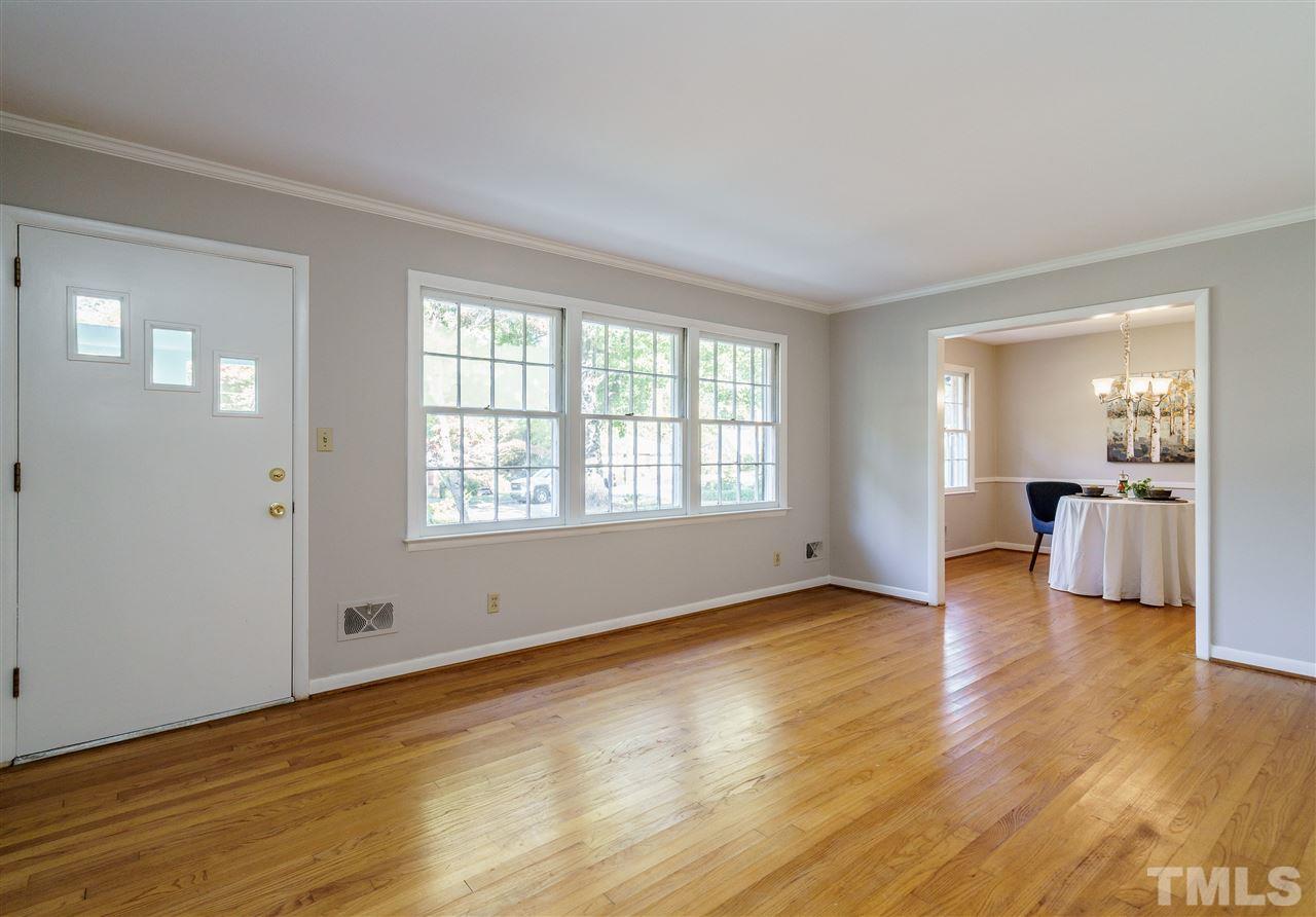 4224 Rowan Street Raleigh, NC 27609 - Photo 3 of 24 an empty room with wooden floor and windows