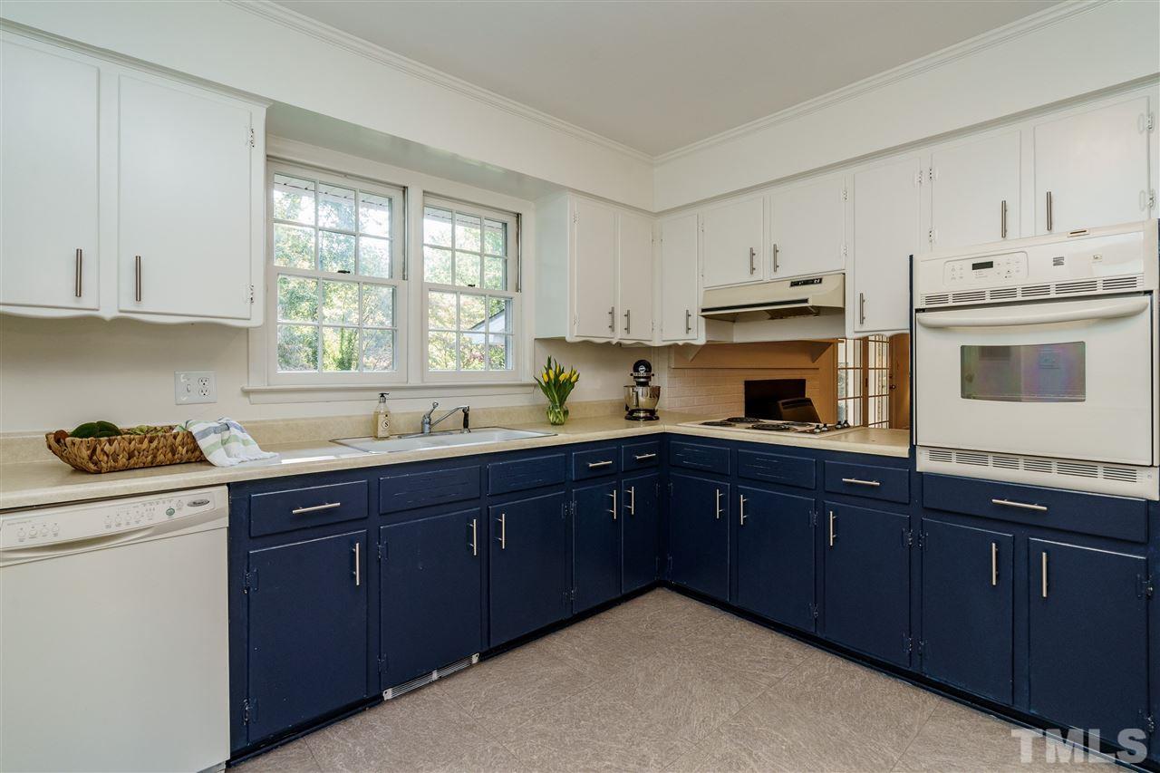 4224 Rowan Street Raleigh, NC 27609 - Photo 10 of 24 a kitchen with stainless steel appliances granite countertop a sink a stove and cabinets