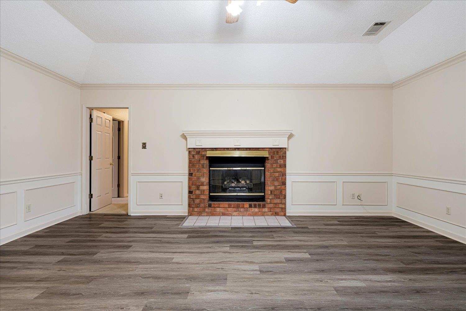 489 Autumn Trail Cove Collierville, TN 38017 - Photo 8 of 30 a view of a livingroom with wooden floor and a fireplace
