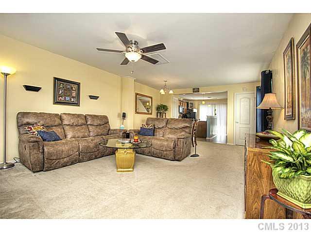 661 Potter Place Road, Unit 106 Fort Mill, SC 29708 - Photo 2 of 16 a living room with furniture and a chandelier