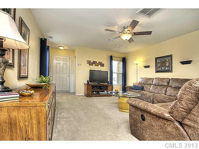 661 Potter Place Road, Unit 106 Fort Mill, SC 29708 - Photo 3 of 16 a living room with furniture and a flat screen tv