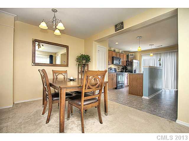 661 Potter Place Road, Unit 106 Fort Mill, SC 29708 - Photo 4 of 16 a dining room with furniture and a kitchen view
