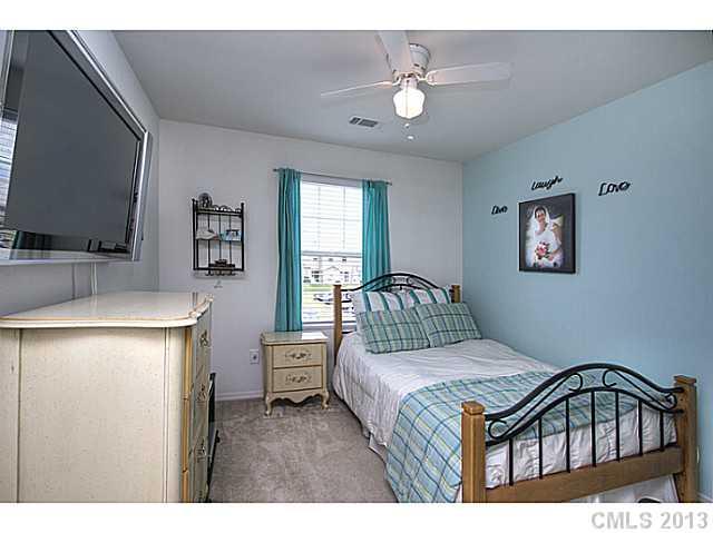 661 Potter Place Road, Unit 106 Fort Mill, SC 29708 - Photo 10 of 16 a bedroom with a bed and a chandelier