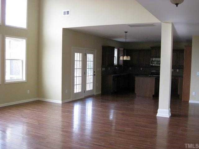 2101 Lower Lake Road Wake Forest, NC 27587 - Photo 2 of 12 Beautiful 2-story family room with hardwood floors, fireplace & built-in bookcase (not shown) is open to great kitchen with quartz countertops, tile backsplash, stainless appliances, & more!