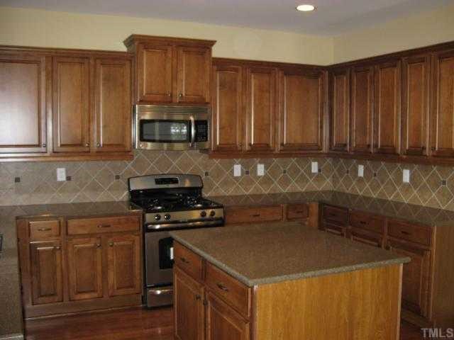 2101 Lower Lake Road Wake Forest, NC 27587 - Photo 3 of 12 Beautiful kitchen with Zodiac quartz counters, tile backsplash, stainless appliances, and more!