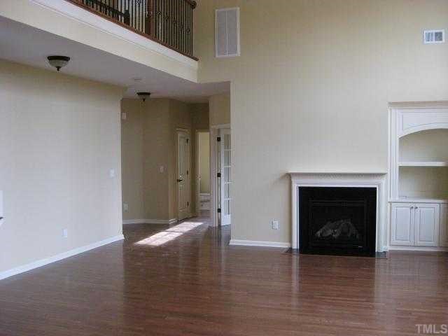 2101 Lower Lake Road Wake Forest, NC 27587 - Photo 4 of 12 Large 2-story family room with hardwood floors, gas fireplace & built-in bookshelf. Catwalk above with iron rails!