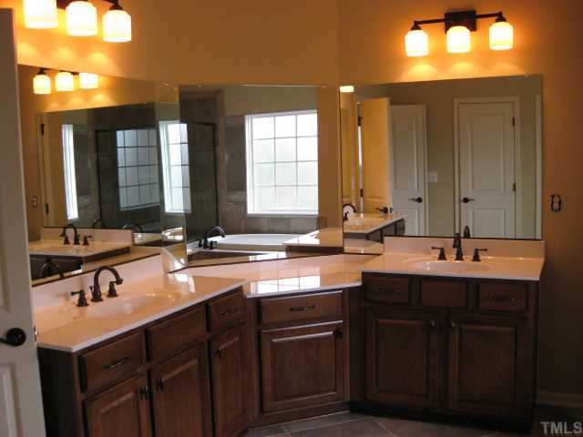 2101 Lower Lake Road Wake Forest, NC 27587 - Photo 7 of 12 Great master bathroom with tiled floor, separate sinks, garden tub with tile surround, and walk-in shower with tile surround. Large walk-in closet off bathroom too!