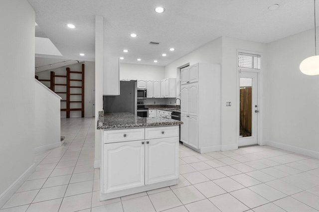 a large kitchen with white cabinets