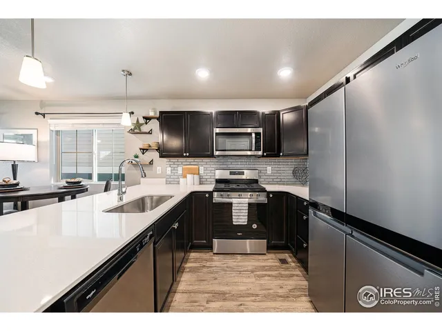 a kitchen with kitchen island a sink stainless steel appliances and cabinets